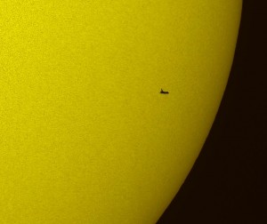 The Space Shuttle silhouetted against the Sun